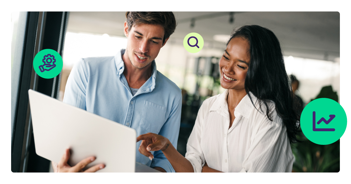 Man and a lady look at a computer together, both smiling