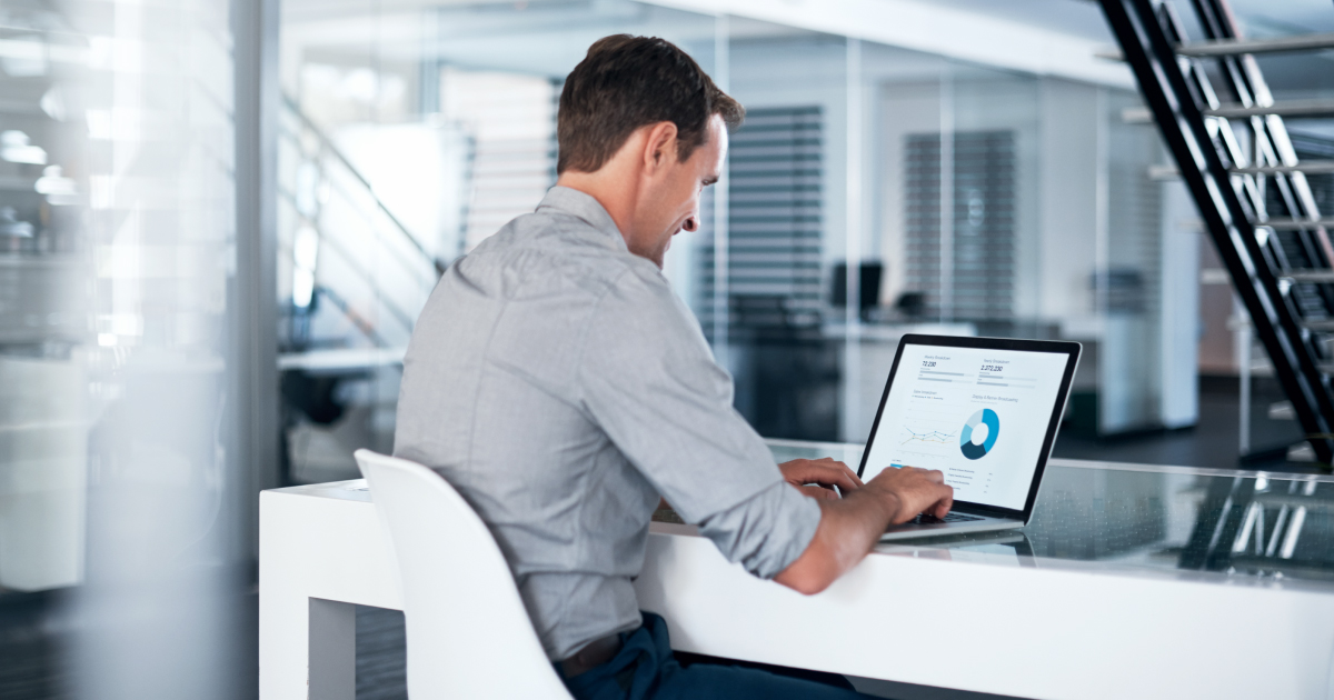 Image of a man using an automated risk scoring system to underwrite his merchants