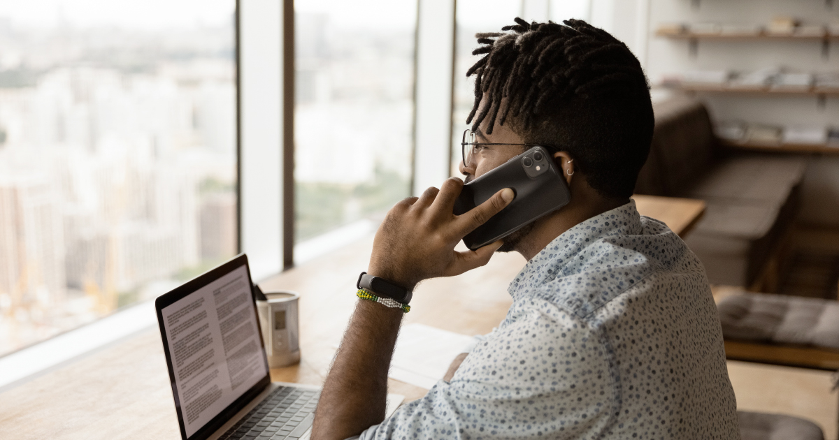 Image of a man talking on the phone about cybersecurity awareness month and payments