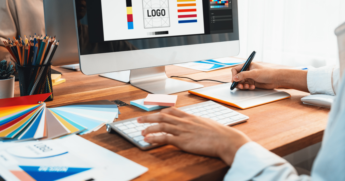 Person designing a logo and brand elements on a computer, representing white-labeling opportunities for SaaS payment platforms.