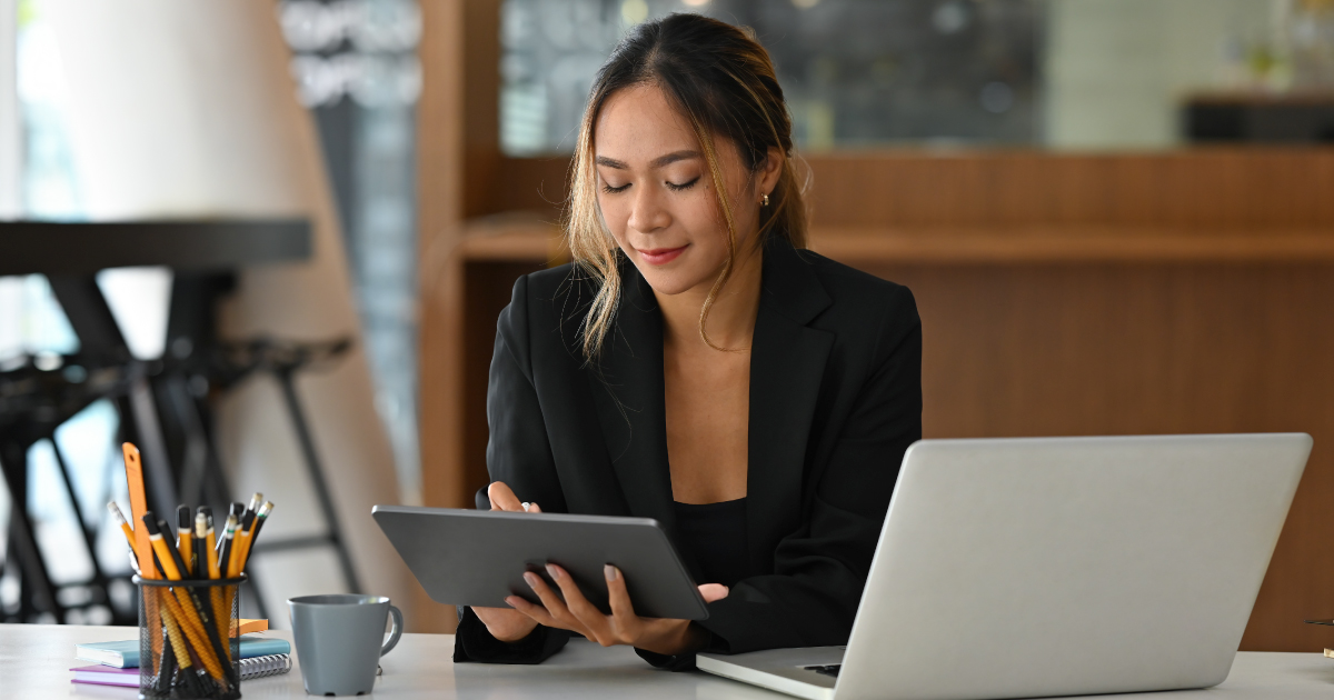 Small business owner using a tablet to explore embedded lending options integrated into SaaS platforms, representing faster access to working capital.