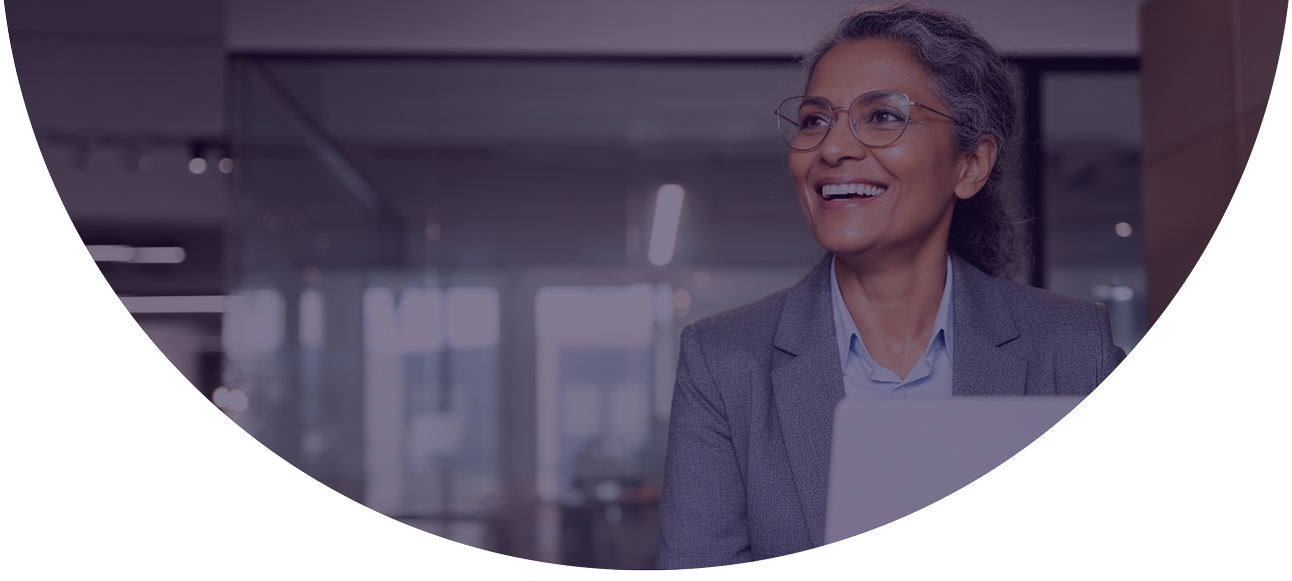 Smiling woman in glasses and a blazer holding a laptop, representing an ISO or payments professional using NMI Merchant Central's integrated helpdesk to manage merchant support from a single platform.