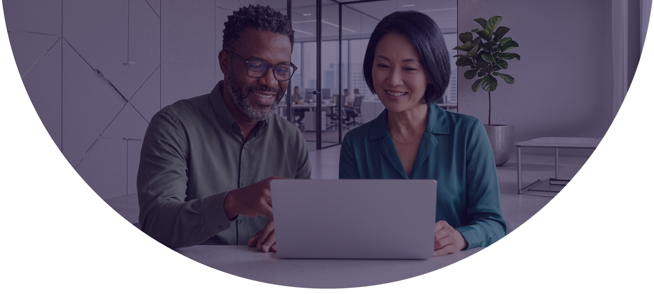 Two payments professionals smiling while reviewing merchant onboarding workflows together on a laptop using NMI Merchant Central's streamlined sign-up and onboarding platform.