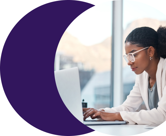 Payments professional in glasses intently reviewing chargeback and dispute data on a laptop using Merchant Central's advanced dispute reporting and management tools.