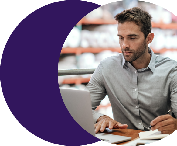 image (automatically populate applications from signed MPAs) Payments professional reviewing a signed merchant processing application on a laptop while TurboApp automatically populates processor boarding fields inside Merchant Central.