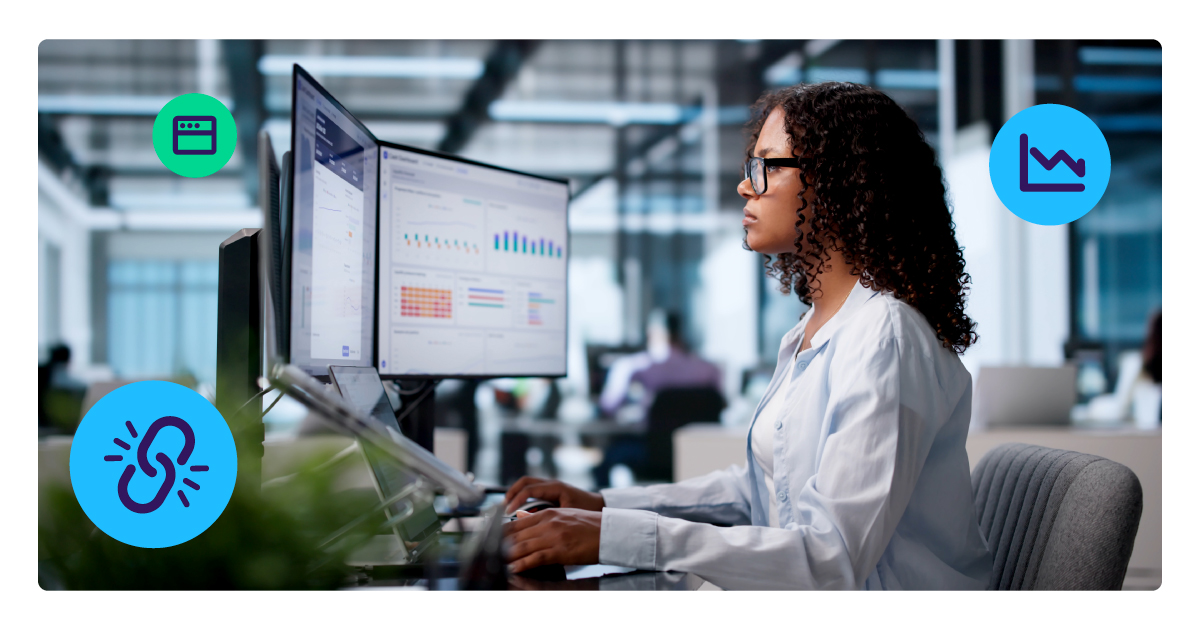Payments professional reviews merchant data dashboards on dual monitors, with icons for reporting, gateways and connected tools