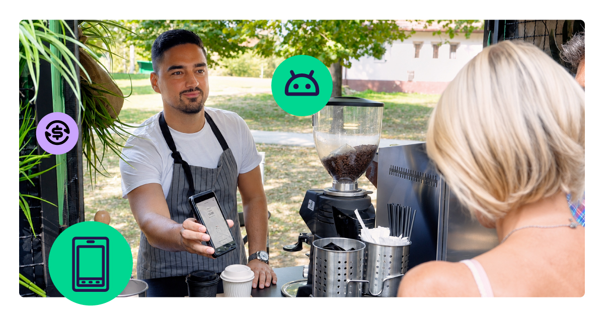 A barista in an apron holds out an Android smart POS device for a customer to tap her card at an outdoor coffee stand.
