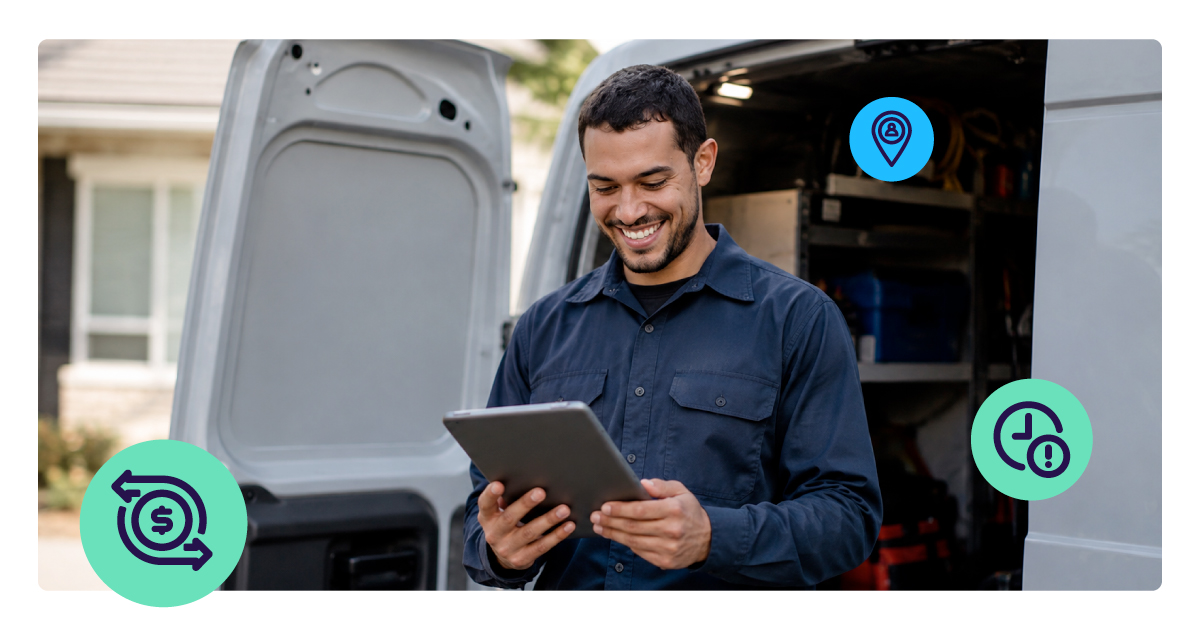 A smiling field service technician in a work uniform stands beside his van, using a tablet to invoice a completed job.