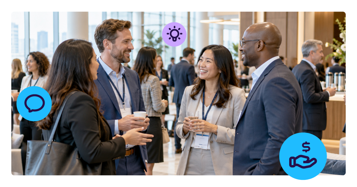 Conference attendees wearing lanyards talk in small groups over coffee in a bright venue lobby.